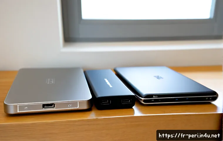 최고의 외장 하드 드라이브 추천 - Photorealistic product comparison scene of three unbranded portable external hard drives in differen...